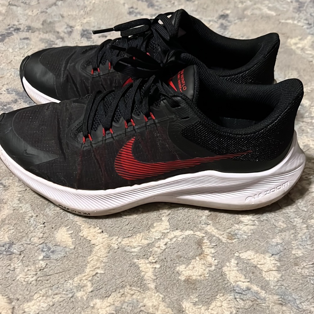 Black and red Nike shoes.